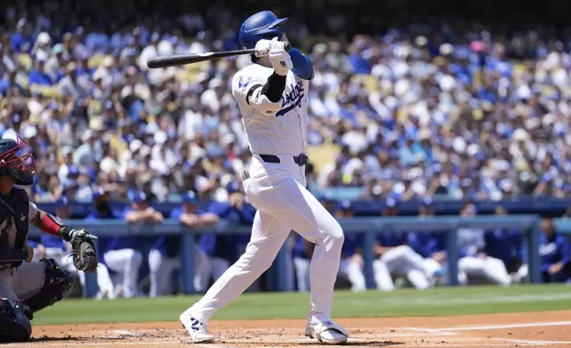 Los Angeles Dodgers designated hitter Shohei Ohtani hits home run during the first inning of a baseball game against the Atlanta Braves in Los Angeles, Sunday, May 5, 2024. Mookie Betts also scored. (AP Photo/Ashley Landis)