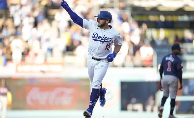 Los Angeles Dodgers' Max Muncy (13) celebrates as he runs the bases after hitting a home run during the second inning of a baseball game against the Atlanta Braves in Los Angeles, Saturday, May 4, 2024. (AP Photo/Ashley Landis)