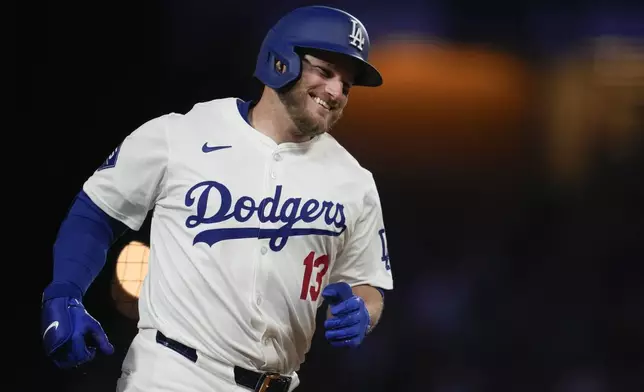 Los Angeles Dodgers' Max Muncy runs the bases after hitting a home run during the eighth inning of a baseball game against the Atlanta Braves in Los Angeles, Saturday, May 4, 2024. (AP Photo/Ashley Landis)