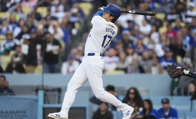 Los Angeles Dodgers designated hitter Shohei Ohtani (17) hits a home run during the third inning of a baseball game against the Atlanta Braves in Los Angeles, Saturday, May 4, 2024. (AP Photo/Ashley Landis)