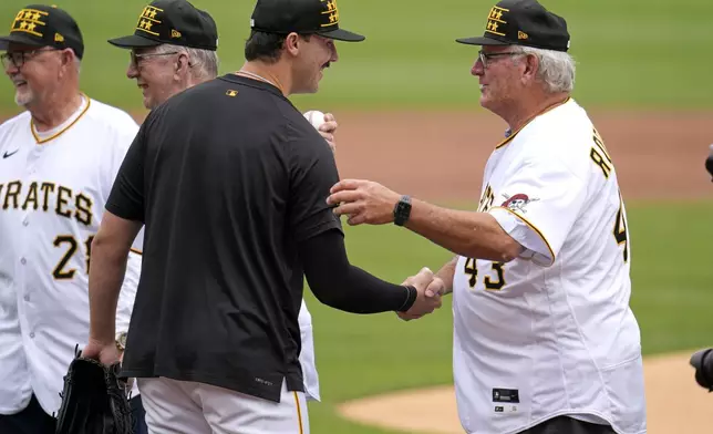 Pittsburgh Pirates pitcher Paul Skenes, center, meets former Pirates pitchers from the 1979 World Series Championship team, left to right, Bert Blyleven, Kent Tekulve, and Don Robinson before a baseball game against the Atlanta Braves in Pittsburgh, Saturday, May 25, 2024. (AP Photo/Gene J. Puskar)