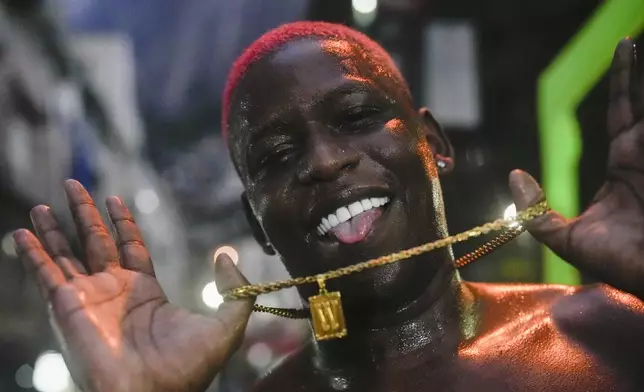 FILE - A youth strikes a pose after performing street dance style known as passinho in the Rocinha favela of Rio de Janeiro, Brazil, Thursday, April 11, 2024. The passinho, or "little step", created in the 2000s by kids in Rio's favelas, was declared an "intangible cultural heritage" by state legislators, bringing recognition to a cultural expression born in the sprawling working-class neighborhoods. (AP Photo/Silvia Izquierdo, File)