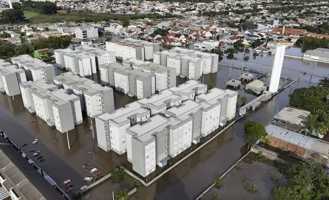 Residential buildings stand in flood water after heavy rain in Canoas, Rio Grande do Sul state, Brazil, Wednesday, May 8, 2024. (AP Photo/Carlos Macedo)