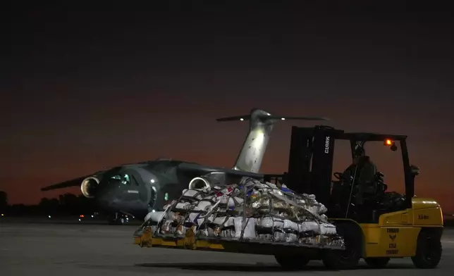 Military prepare to load supplies on an Air Force plane, to transport to victims and people who lost their homes from floods caused by heavy rains in the cities of the Rio Grande do Sul state, at the Air Base in Brasilia, Brazil, Saturday, May 11, 2024. (AP Photo/Eraldo Peres)