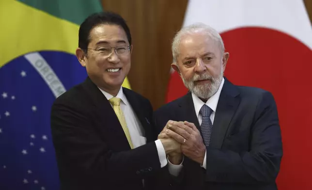Brazil's President Luiz Inacio Lula da Silva, right, and Japan's Prime Minister Fumio Kishida pose for photos at Planalto presidential palace in Brasilia, Brazil, Friday, May 3, 2024. (AP Photo/Luis Nova)