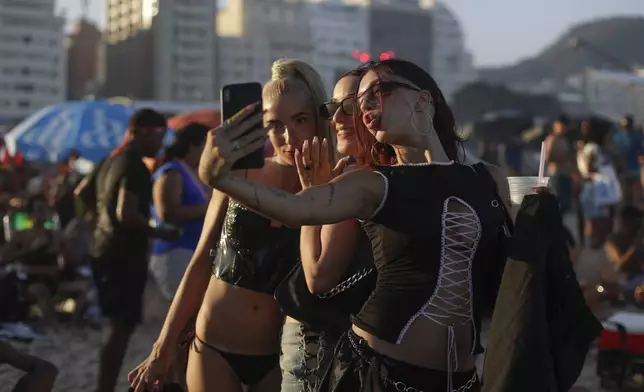Fans take a selfie as they wait for the start of Madonna's last show of The Celebration Tour, on Copacabana beach in Rio de Janeiro, Brazil, Saturday, May 4, 2024. (AP Photo/Bruna Prado)