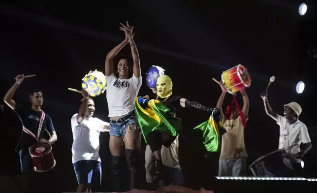 Madonna rehearses in a mask for her Celebration tour in Rio de Janeiro, Brazil, Thursday, May 2, 2024. Madonna, who removed her mask at the end of rehearsal, will conclude her tour on Saturday with a free concert at Copacabana Beach. (AP Photo/Bruna Prado)