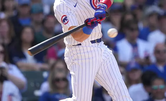 Chicago Cubs' Patrick Wisdom hits an RBI single off Milwaukee Brewers relief pitcher Bryan Hudson during the eighth inning of a baseball game Saturday, May 4, 2024, in Chicago. (AP Photo/Charles Rex Arbogast)