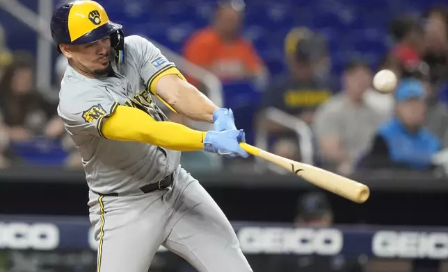 Milwaukee Brewers' Willy Adames hits a double during the third inning of a baseball game against the Miami Marlins, Tuesday, May 21, 2024, in Miami. (AP Photo/Lynne Sladky)