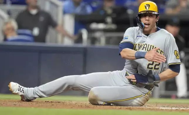 Milwaukee Brewers' Christian Yelich (22) reacts after he was tagged out at the plate during the third inning of a baseball game against the Miami Marlins, Tuesday, May 21, 2024, in Miami. (AP Photo/Lynne Sladky)