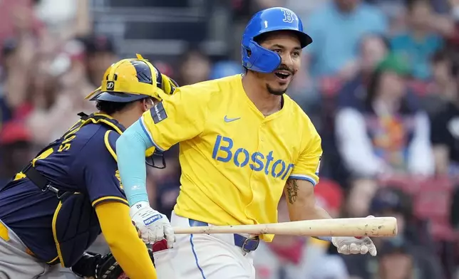 Boston Red Sox's David Hamilton, right, reacts in front of Milwaukee Brewers catcher William Contreras, left, after striking out swinging to end a baseball game Saturday, May 25, 2024, in Boston. (AP Photo/Michael Dwyer)