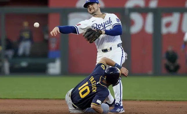 Kansas City Royals second baseman Michael Massey throws to first after forcing Milwaukee Brewers' Sal Frelick (10) out at second on a force out hit into by William Contreras during the fifth inning of a baseball game Tuesday, May 7, 2024, in Kansas City, Mo. (AP Photo/Charlie Riedel)