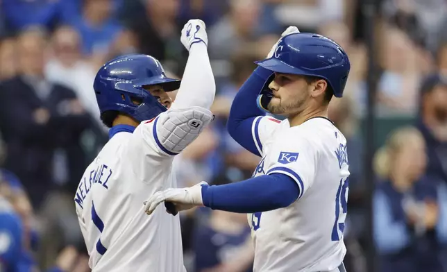 Kansas City Royals' Michael Massey (19) celebrates with MJ Melendez (1) after crossing home plate after hitting a solo home run during the seventh inning of a baseball game against the Milwaukee Brewers in Kansas City, Mo., Monday, May 6, 2024. (AP Photo/Colin E. Braley)