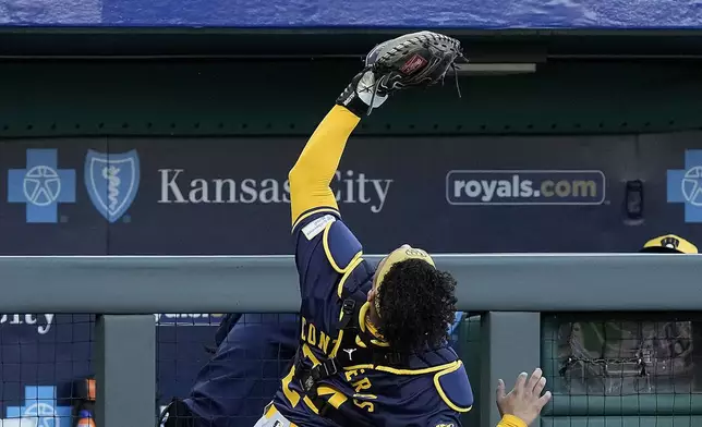 Milwaukee Brewers catcher William Contreras catches a fly foul ball for the out on Kansas City Royals' Michael Massey during the fourth inning of a baseball game Tuesday, May 7, 2024, in Kansas City, Mo. (AP Photo/Charlie Riedel)