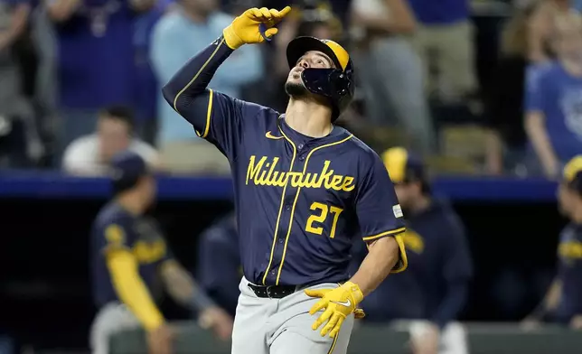 Milwaukee Brewers' Willy Adames celebrates as he crosses the plate after hitting a three-run home run during the ninth inning of a baseball game against the Kansas City Royals Tuesday, May 7, 2024, in Kansas City, Mo. The Brewers won 6-5. (AP Photo/Charlie Riedel)