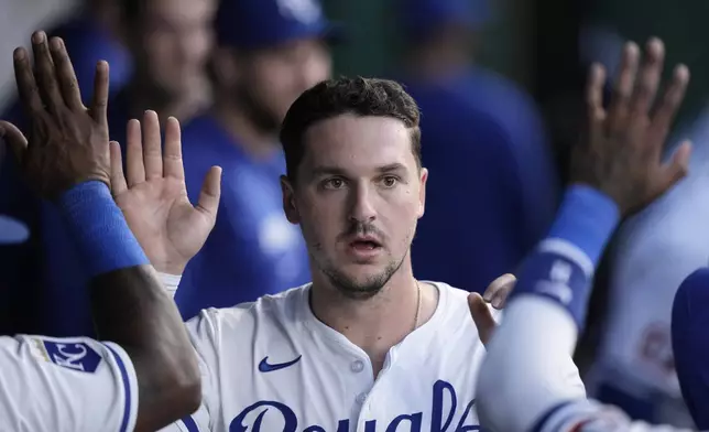 Kansas City Royals' Vinnie Pasquantino celebrates in the dugout after scoring on an RBI double hit by Salvador Perez during the fifth inning of a baseball game against the against the Milwaukee Brewers Tuesday, May 7, 2024, in Kansas City, Mo. (AP Photo/Charlie Riedel)