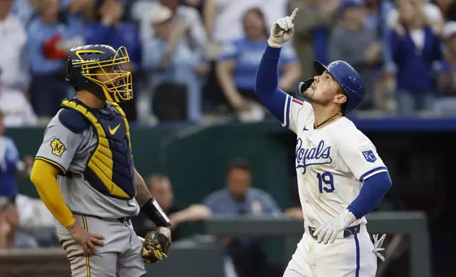 Kansas City Royals' Michael Massey (19) reacts as he crosses home plate next to Milwaukee Brewers catcher Gary Sánchez, left, during the seventh inning of a baseball game in Kansas City, Mo., Monday, May 6, 2024. (AP Photo/Colin E. Braley)