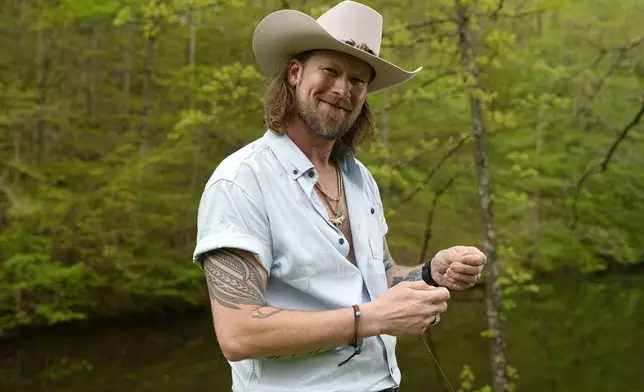 Brian Kelley poses for a portrait outside his cabin Wednesday, April 17, 2024, in Nashville, Tenn. (AP Photo/George Walker IV)