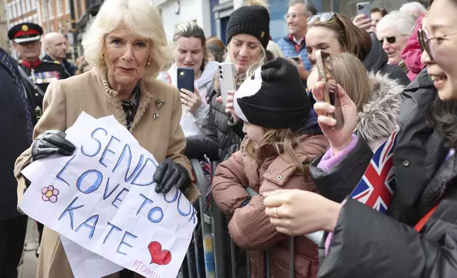 FILE - Britain's Queen Camilla receives a message of support for Princess Catherine, during her visit to the Farmers' Market in Shrewsbury, England, Wednesday March 27, 2024. Camilla has emerged as one of the monarchy’s most prominent emissaries. Increasing her schedule of appearances, the queen played a crucial role in keeping the royal family in the public eye. (Chris Jackson/Pool via AP, File)