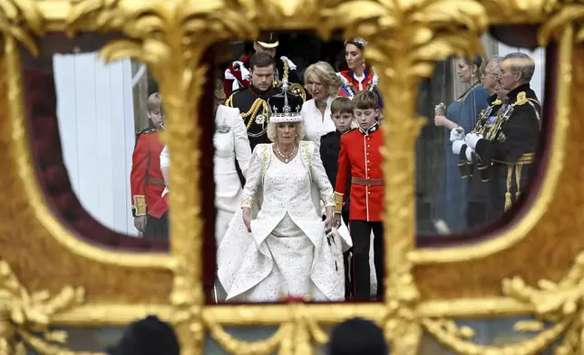 FILE - Britain's Queen Camilla leaves Westminster Abbey following her coronation ceremony, in London, Saturday, May 6, 2023. Camilla has emerged as one of the monarchy’s most prominent emissaries. Increasing her schedule of appearances, the queen played a crucial role in keeping the royal family in the public eye. (Toby Melville, Pool via AP, File)