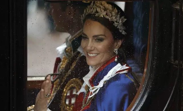 FILE - Kate, Princess of Wales and Prince William travel in a coach following the coronation ceremony of Britain's King Charles III in London, Saturday, May 6, 2023. (AP Photo/David Cliff, File)
