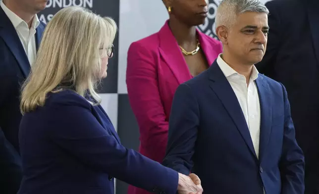 Conservative Party mayoral candidate Susan Hall, left, shakes hands with the winning Labour Party's Sadiq Khan on stage as he is re-elected for a record third time as Mayor of London, following the counting of votes, at City Hall in London, Saturday, May 4, 2024. Khan, the Labour Party's Mayor of London, has romped to victory, securing a record third straight term at City Hall, on another hugely disappointing day for the U.K.'s governing Conservatives ahead of a looming general election. (AP Photo/Alastair Grant)