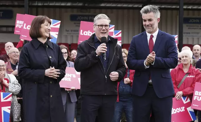 Britain's Labour Party leader Sir Keir Starmer, center, and shadow chancellor Rachel Reeves, celebrate with David Skaith at Northallerton Town Football Club, North Yorkshire, after winning the York and North Yorkshire mayoral election, Friday May 3, 2024. (Owen Humphreys/PA via AP)