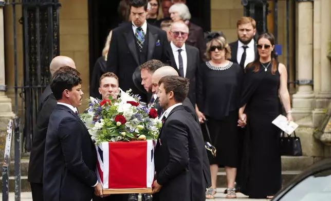 The coffin of British aid worker James Henderson, one of the seven World Central Kitchen (WCK) workers killed in an Israeli air strike in Gaza, is carried out of Truro Cathedral, after his funeral, in Truro, England, Wednesday May 22, 2024. (Ben Birchall/PA via AP)