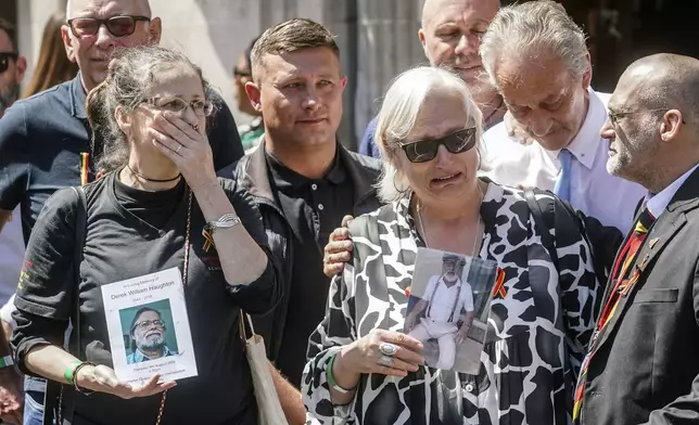 Cressida Haughton, left, who's father Derek and Deborah Dennis who's father Dennis died, gather outside the Central Hall in Westminster in London, after the publication of the Infected Blood Inquiry report, Monday May 20, 2024. British authorities and the country's public health service knowingly exposed tens of thousands of patients to deadly infections through contaminated blood and blood products, and hid the truth about the disaster for decades, an inquiry into the U.K.’s infected blood scandal found Monday. (Jeff Moore/PA via AP)