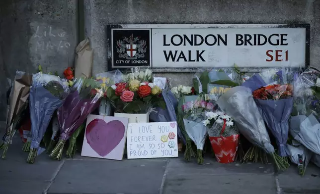 FILE - In this Monday, Dec. 2, 2019 file photo, tributes are placed by the southern end of London Bridge, three days after a man stabbed two people to death and injured three others before being shot dead by police, in London. Knife crimes are on the rise in England and Wales, and a string of deadly attacks in recent years has stoked public anxiety and led to calls for the government to do more. (AP Photo/Matt Dunham, file)