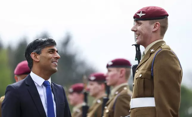 Britain's Prime Minister Rishi Sunak smiles as he inspects the Passing Out Parade of the Parachute Regiment recruits during his visit to the Helles Barracks at the Catterick Garrison, a military base in North Yorkshire, Britain, Friday, May 3, 2024. (Molly Darlington/Pool photo via AP)