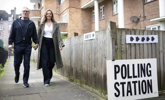 Labour leader Keir Starmer and his wife Victoria arrive at their local polling station to cast their vote in the local and London Mayoral election, in north London, Thursday, May 2, 2024. Millions of voters in England and Wales will cast their ballots on Thursday in an array of local elections that will be the last big test before a U.K. general election that all indicators show will see the Conservative Party ousted from power after 14 years. (Stefan Rousseau/PA Wire/PA via AP)