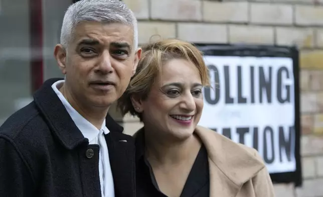 London Mayoral Labour Party candidate Sadiq Khan and his wife Saadiya Ahmed pose for the media as they arrive to vote in London, Thursday, May 2, 2024. Khan, is seeking re-election, and standing against 12 other candidates for the post of Mayor of London. There are other Mayoral elections in English cities and as well as local council elections. (AP Photo/Kin Cheung)