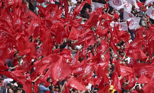 Manchester United fans wave flags ahead of the English FA Cup final soccer match between Manchester City and Manchester United at Wembley Stadium in London, Saturday, May 25, 2024. (AP Photo/Ian Walton)