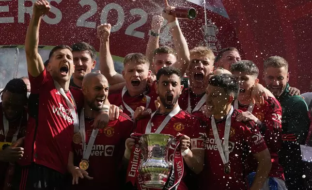 Manchester United's Bruno Fernandes holds the trophy after his team won the English FA Cup final soccer match between Manchester City and Manchester United at Wembley Stadium in London, Saturday, May 25, 2024. Manchester United won 2-1. (AP Photo/Kin Cheung)