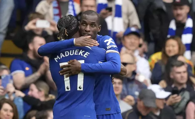 Chelsea's Nicolas Jackson, right, celebrates with Chelsea's Noni Madueke after scoring his side's fourth goal during the English Premier League soccer match between Chelsea and West Ham United at Stamford Bridge stadium in London, England, Sunday, May 5, 2024. (AP Photo/Frank Augstein)