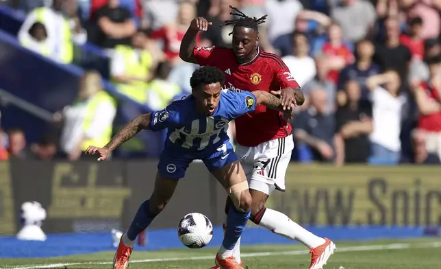 Brighton's Joao Pedro, left and Manchester United's Aaron Wan-Bissaka vie for the ball, during the English Premier League soccer match between Brighton &amp; Hove Albion and Manchester United, at the Amex Stadium, in Brighton and Hove, England, Sunday, May 19, 2024. (Steven Paston/PA via AP)