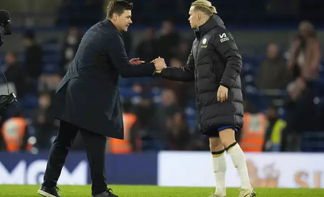 Chelsea's head coach Mauricio Pochettino shakes hands with Chelsea's Mykhailo Mudryk at the end of the English Premier League soccer match between Chelsea and Tottenham Hotspur at Stamford Bridge stadium in London, Thursday, May 2, 2024. (AP Photo/Kirsty Wigglesworth)