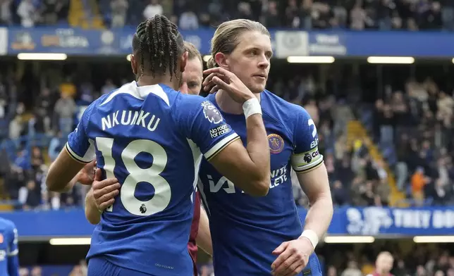 Chelsea's Conor Gallagher, right, and Chelsea's Christopher Nkunku at the end of the English Premier League soccer match between Chelsea and West Ham United at Stamford Bridge stadium in London, England, Sunday, May 5, 2024. (AP Photo/Frank Augstein)
