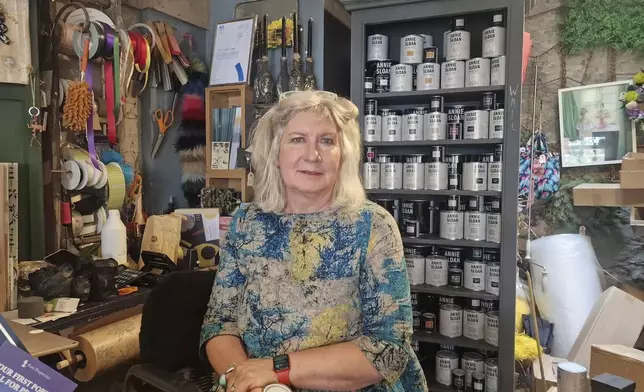 Sally Dart, who runs Flotsam 50 near Brixham Harbour, a shop that sells artwork, furniture, and flowers poses in Brixham, Friday May 17, 2024. Around 16,000 homes and businesses in the Brixham area of Devon were told to boil water after cryptosporidium, a microscopic parasite that causes diarrhea, was found in the water. Sally Dart, who runs a housewares shop near Brixham Harbor, said people in town first began feeling ill two weeks ago during a pirate festival. "No one was checking the quality of the water and we’ve all got sick and it’s stupid,” she said. (Piers Mucklejohn/PA via AP)