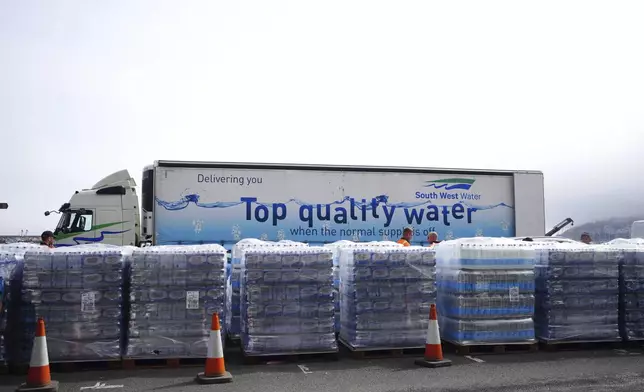 Bottled water is seen at Freshwater car park in Brixham, England, Friday May 17, 2024. Around 16,000 households and businesses in the Brixham area of Devon have been told not to use their tap water for drinking without boiling and cooling it first, following the discovery of small traces of a parasite in the local water network. (Ben Birchall/PA via AP)