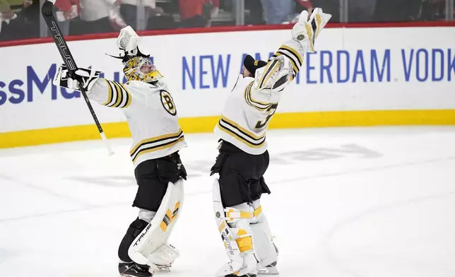 Boston Bruins goaltenders Jeremy Swayman, left, and Linus Ullmark celebrate after the Bruins beat the Florida Panthers 2-1 during Game 5 of the second-round series of the Stanley Cup Playoffs, Tuesday, May 14, 2024, in Sunrise, Fla. (AP Photo/Wilfredo Lee)