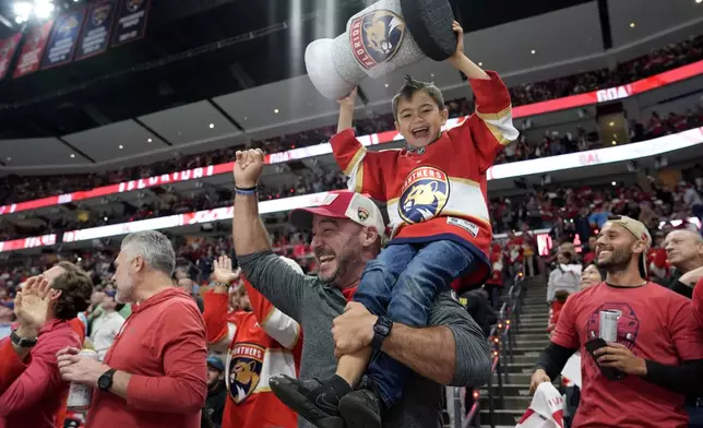Florida Panthers fans celebrate after the Panthers scored a goal against the Boston Bruins during the second period in Game 2 of a second-round series of the NHL hockey Stanley Cup playoffs Wednesday, May 8, 2024, in Sunrise, Fla. (AP Photo/Lynne Sladky)