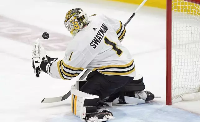 Boston Bruins goaltender Jeremy Swayman makes a save during the second period of Game 5 of the second-round series of the Stanley Cup Playoffs against the Florida Panthers, Tuesday, May 14, 2024, in Sunrise, Fla. (AP Photo/Wilfredo Lee)