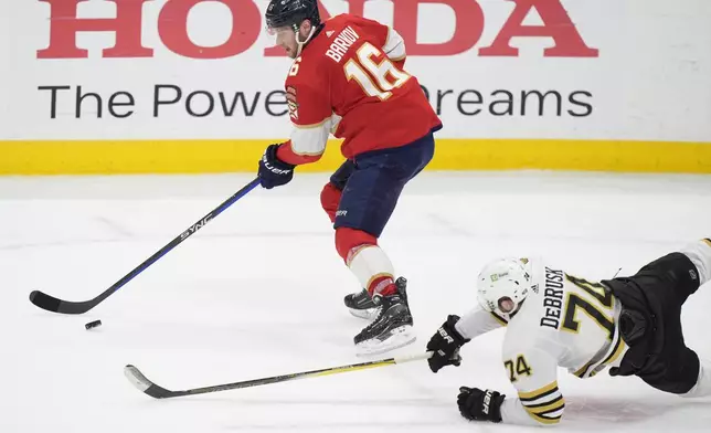 Florida Panthers center Aleksander Barkov (16) and Boston Bruins left wing Jake DeBrusk (74) battle for the puck during the second period of Game 5 of the second-round series of the Stanley Cup Playoffs, Tuesday, May 14, 2024, in Sunrise, Fla. (AP Photo/Wilfredo Lee)