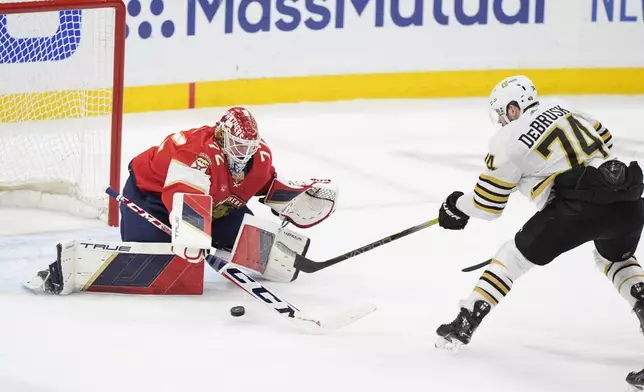 Boston Bruins left wing Jake DeBrusk (74) attempts a shot at Florida Panthers goaltender Sergei Bobrovsky (72) during the second period of Game 5 of the second-round series of the Stanley Cup Playoffs, Tuesday, May 14, 2024, in Sunrise, Fla. (AP Photo/Wilfredo Lee)