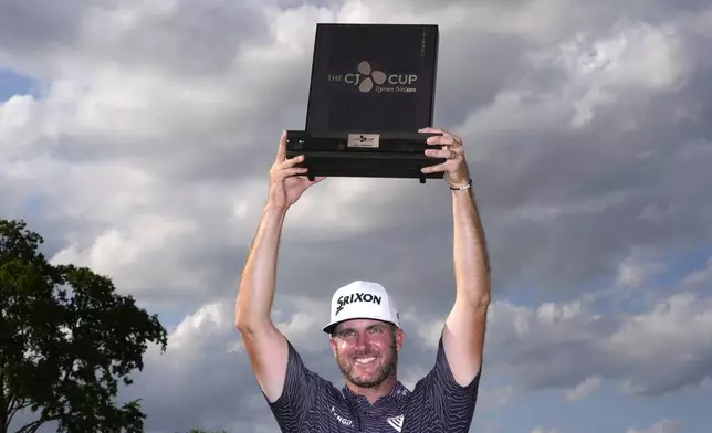 Taylor Pendrith holds up the champion's trophy after winning the Byron Nelson golf tournament in McKinney, Texas, Sunday, May 5, 2024. (AP Photo/LM Otero)