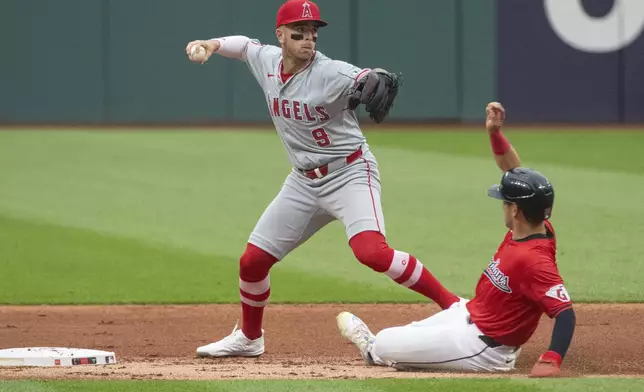CORRECTS TO LOS ANGELES ANGELS NOT CALIFORNIA ANGELS - Los Angeles Angels' Zach Neto (9) forces Cleveland Guardians' Steven Kwan, right, at second base during the first inning of a baseball game in Cleveland Friday, May 3, 2024. (AP Photo/Phil Long)