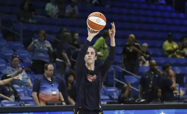 CORRECTS FROM CAITLYN TO CAITLIN - Indiana Fever guard Caitlin Clark warms up prior to an WNBA basketball game against the Dallas Wings in Arlington, Texas, Friday, May 3, 2024. (AP Photo/Michael Ainsworth)