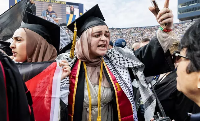 Pro-Palestinian protesters demonstrate during the University of Michigan's Spring 2024 Commencement Ceremony at Michigan Stadium in Ann Arbor, Mich., on Saturday, May 4, 2024.( Jacob Hamilton/Ann Arbor News via AP)